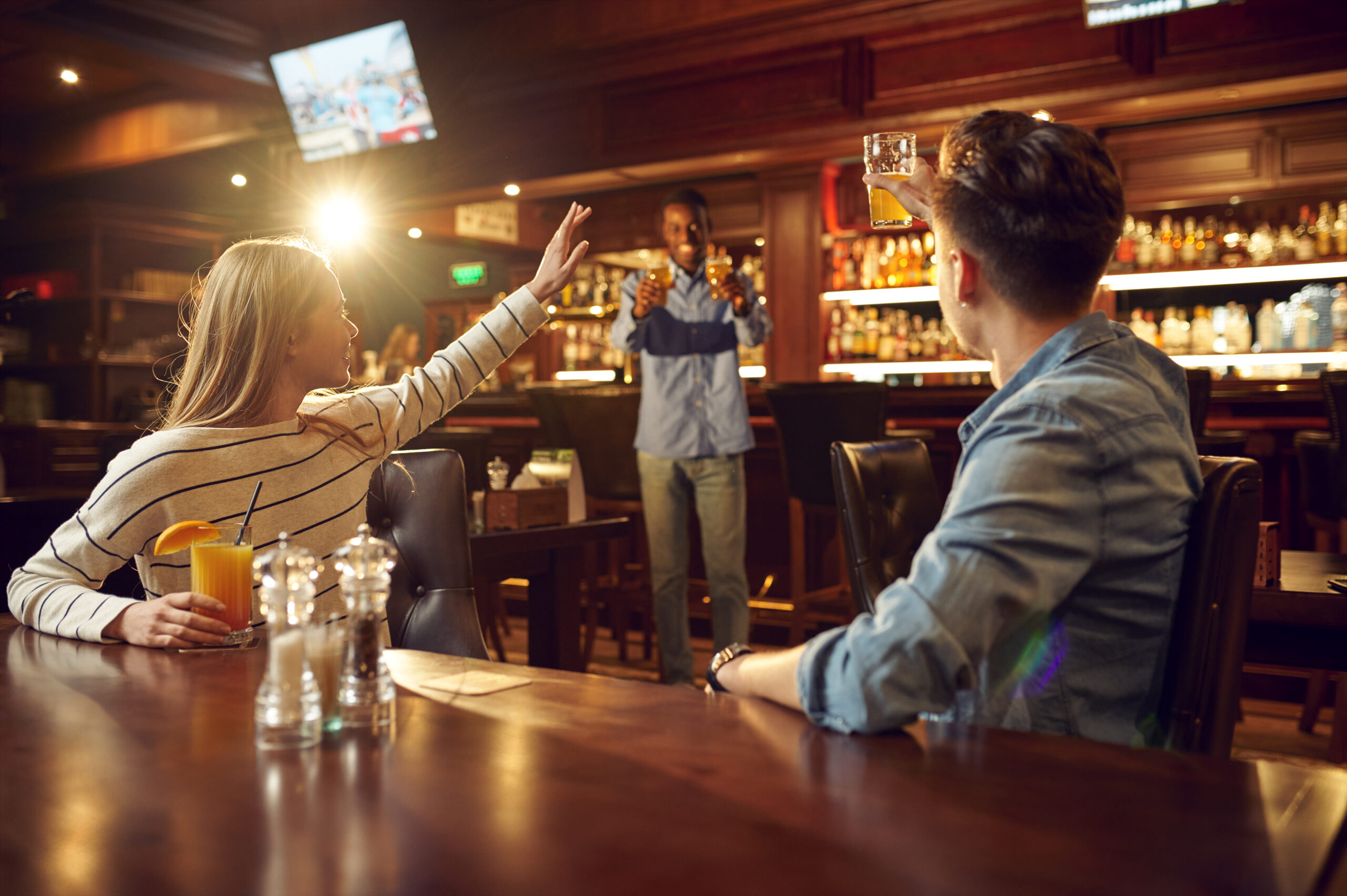 Friends drinks alcohol and having fun in bar